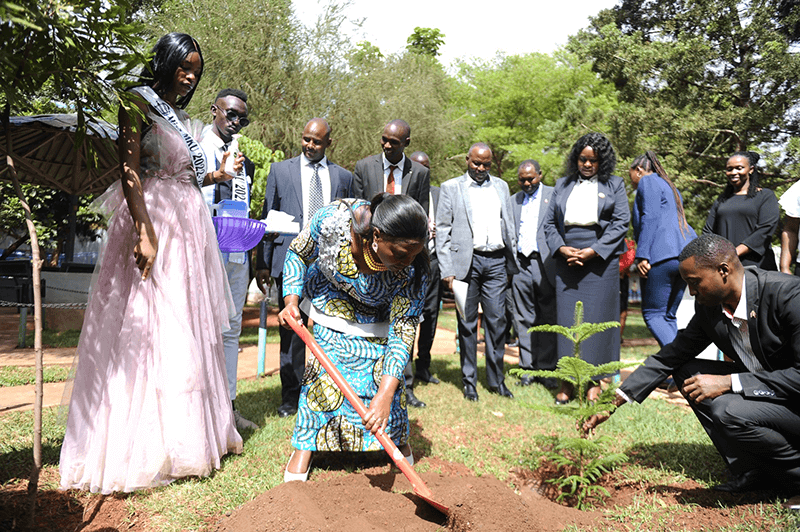 H.E Pastor Dr. Dorcas Rigathi planting a tree to mark the Sikika Youth Fest at Mount Kenya University Study Villas outside the Library